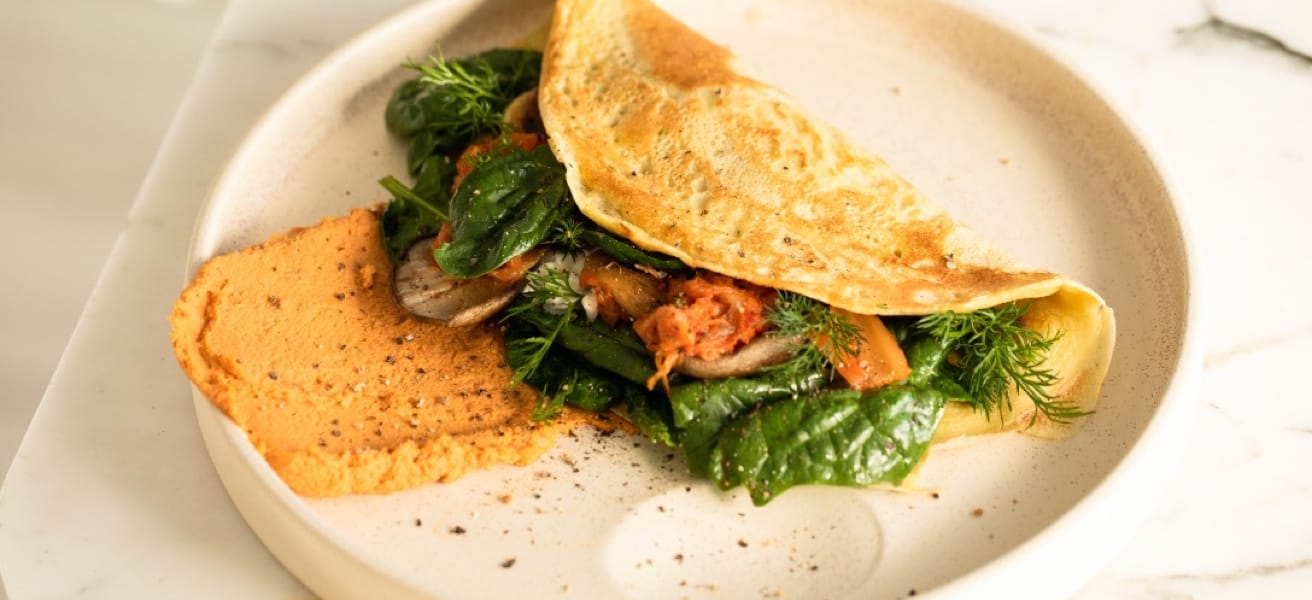 A delicious omelette with greens on a plate